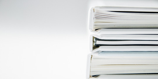 Photo: white full folders stacked horizontally, light background